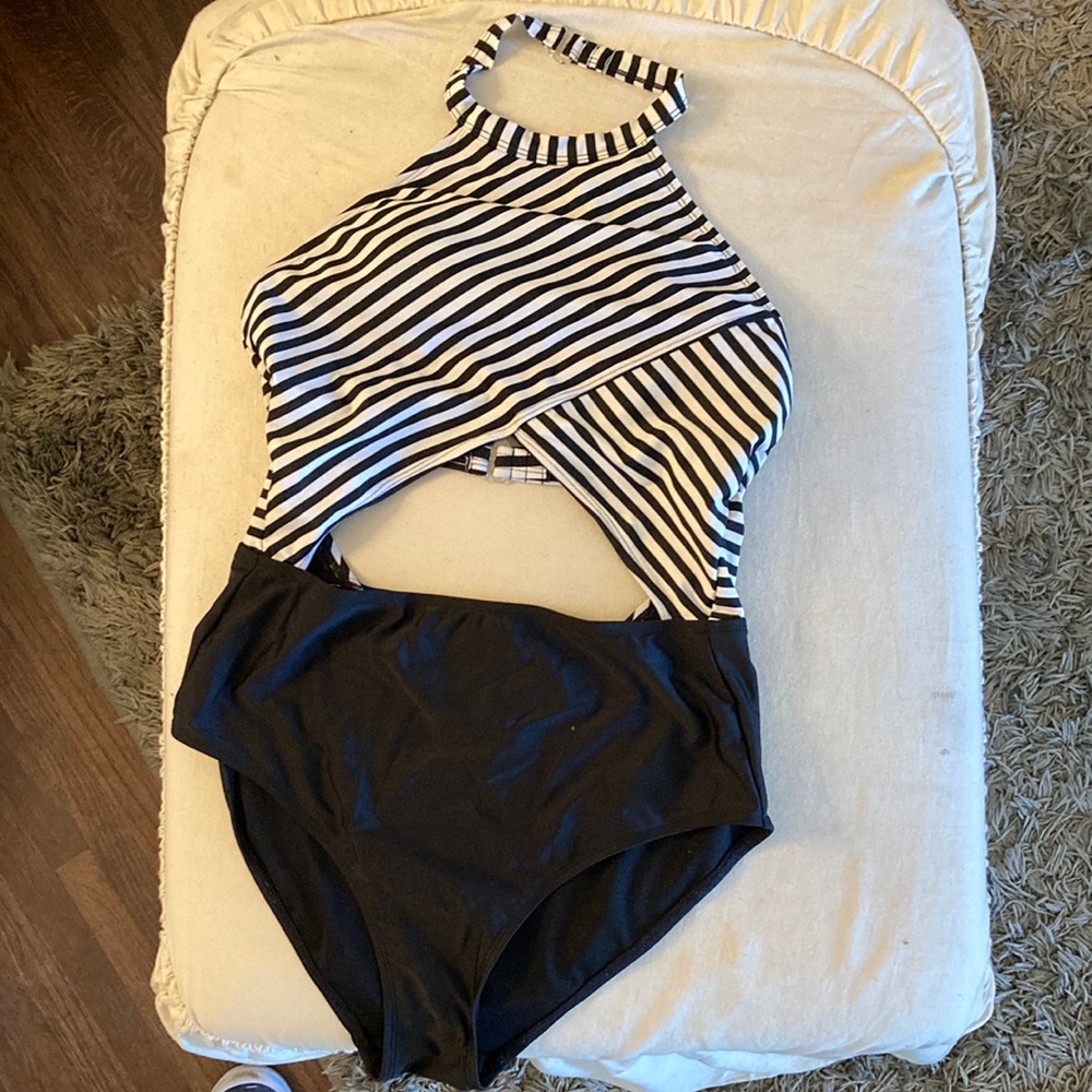 One piece bathing suit size 7-9 stripes and solid bottoms.